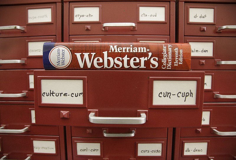 FILE - A Merriam-Webster dictionary sits atop their citation files at the dictionary publisher's offices on Dec. 9, 2014, in Springfield, Mass. Merriam-Webster's word of the year for 2023 is &#x201c;authentic.&#x201d; (AP Photo/Stephan Savoia, File)