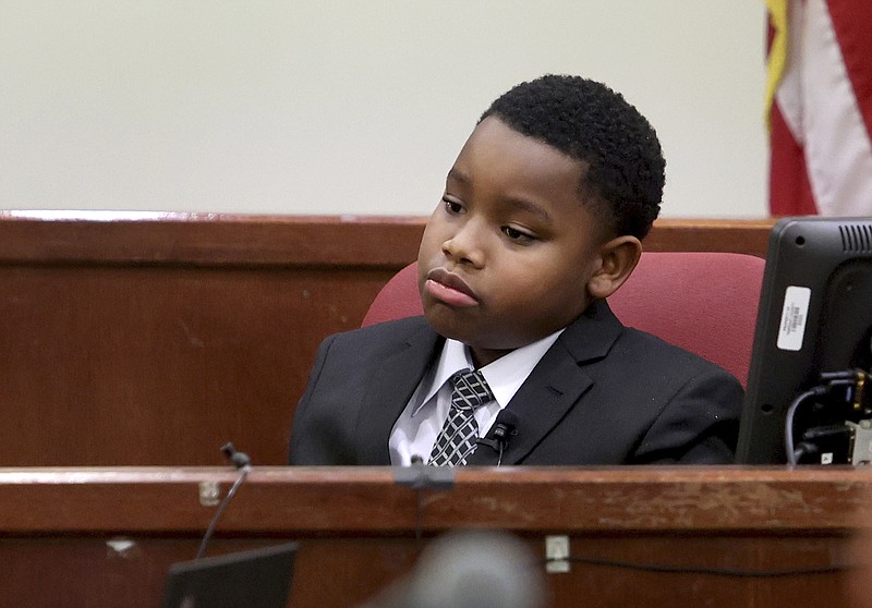 FILE - Zion Carr, 11, testifies during the murder trial of former Fort Worth, Texas, police officer Aaron Dean, Dec. 5, 2022, in Fort Worth. Carr is Atatiana Jefferson's nephew and was present when she was shot and killed by Dean. On Tuesday, Nov. 28, 2023, the Fort Worth City Council approved a $3.5 million settlement for Carr, who witnessed his aunt being fatally shot through a window of her home by the police officer in 2019. (Amanda McCoy/Star-Telegram via AP, Pool, File)