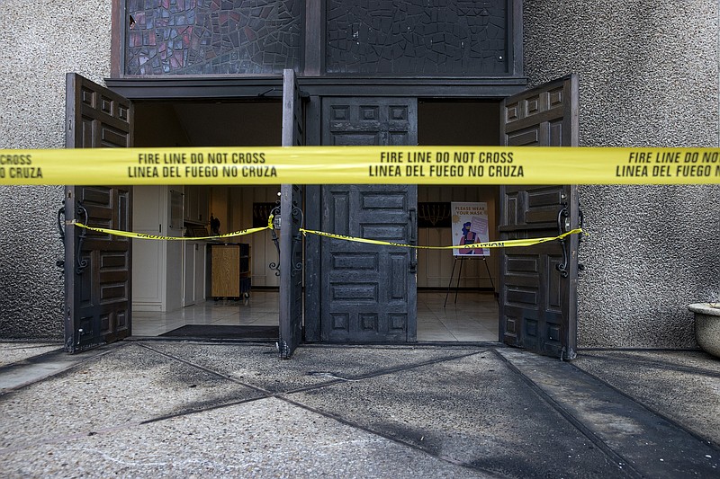 Caution tape marks the front doors at Congregation Beth Israel on Nov. 1, 2021, after someone started a fire at the Central Austin synagogue in Austin, Texas, the previous day. Franklin Sechriest who set fire to the synagogue in an antisemitic attack two years ago was sentenced on Wednesday, Nov. 29, 2023, to 10 years in prison. (Jay Janner/Austin American-Statesman via AP)