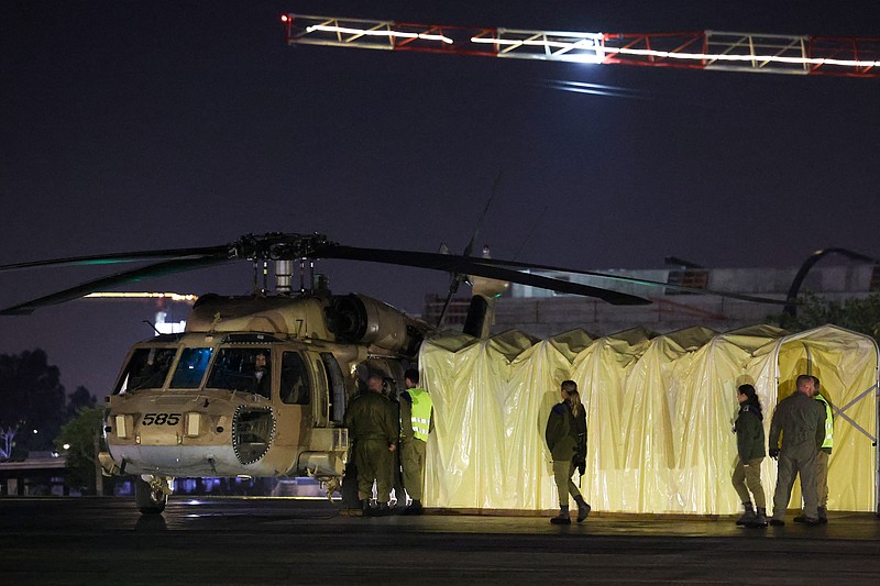 Israeli soldiers stand next to a helicopter carrying two Israeli-Russian hostages taken by Hamas militants on the Oct. 7 attack, and released on Nov. 29, 2023, at the Sheba Medical Center in Ramat Gan. Hamas said on Nov. 29 it had released two women hostages with Russian citizenship in the Gaza Strip, as a truce held between Israel and the Islamist movement in the Palestinian territory. (Jack Guez/AFP/Getty Images/TNS)