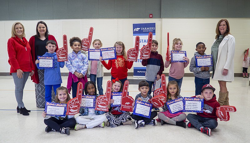 Pictured (left to right, front row) are: East Side Elementary students Margo Hutcheson, Chloe Lambert, Hazel Boswell, Owen Haire, Remi Christenson, and Maddox Graham; and (back row) Talesha Tatom and Jessie Watson of Farmers Bank & Trust, students Jack Watson, Emerald Jeter, Zoey Trusty, Ainsleigh Castleberry, Lawson Hudgens, , Enzley Boggan, Zylen Darius, and Leah Boswell of Farmers Bank & Trust.