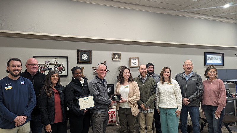 Chamber of Commerce Board Members and city officials present Albemarle employees with the November 2023 Chamber Member of the Month award. (Joshua Turner / Banner-News)