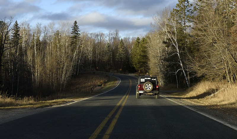 Dennis Nelson drives down a road in remote northern Minnesota to make his mail deliveries. MUST CREDIT: Photos by Dan Koeck for The Washington Post