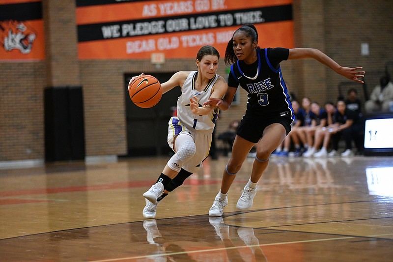 Fouke's Paige Attaway drives againts Rice standout Saniya Burks on Saturday, Dec. 2, 2023, during the Red River Hoopfest at the Tiger Center in Texarkana, Texas. (Photo by Kevin Sutton/TXKSports.com)