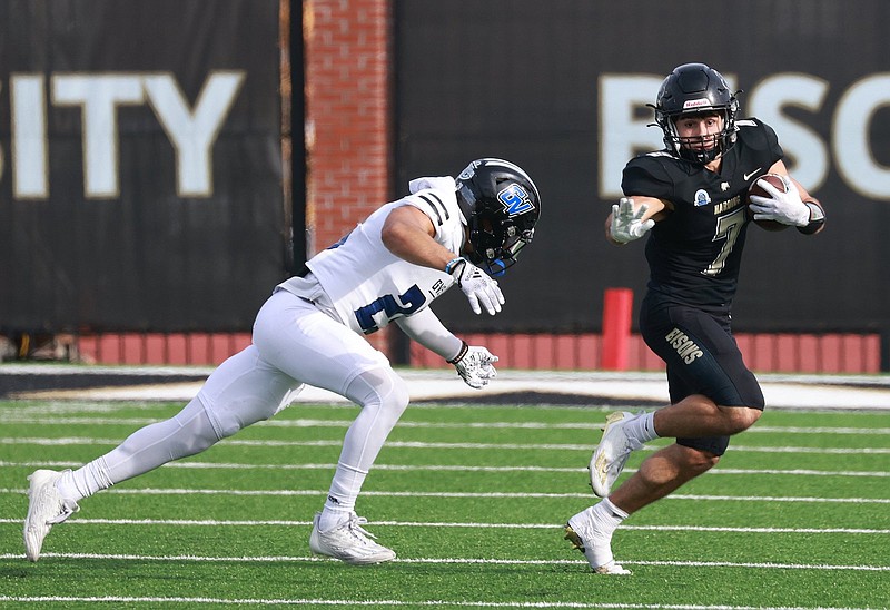 Harding's Braden Jay (7) avoids a tackle by Grand Valley State's Kobe Hayward during a NCAA Division II national quarterfinal game Saturday. (Arkansas Democrat-Gazette/Colin Murphey)