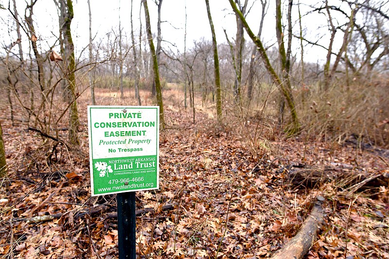 A sign marks property along Schaffer Road Thursday, Jan. 12, 2023, owned by Janet Bachman and Jim Luckens in Washington County. Bachman and Luckens have protected their 128 acres for the future with a conservation easement through the NWA Land Trust. (NWA Democrat-Gazette/Andy Shupe)