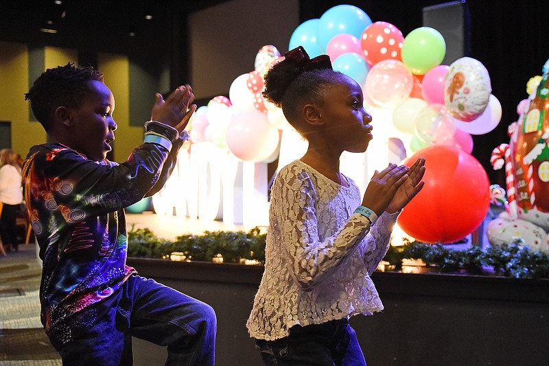 Zhylyn Franklin, 7, and his sister KK, 9, dance to “Church Clap” during the Candyland Christmas event Saturday hosted by the Arkansas Department of Human Services Division of Children and Family Services and Project Zero at the Fellowship Bible Church in Little Rock.
(Arkansas Democrat-Gazette/Staci Vandagriff)
