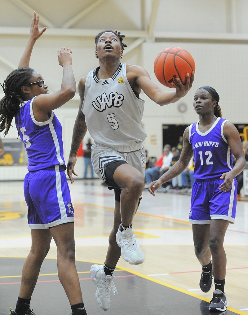 UAPB senior guard Jelissa Reese drives past two defenders to attempt a layup in a Dec. 1 women's basketball game at H.O. Clemmons Arena. (Special to the Commercial/William Harvey)