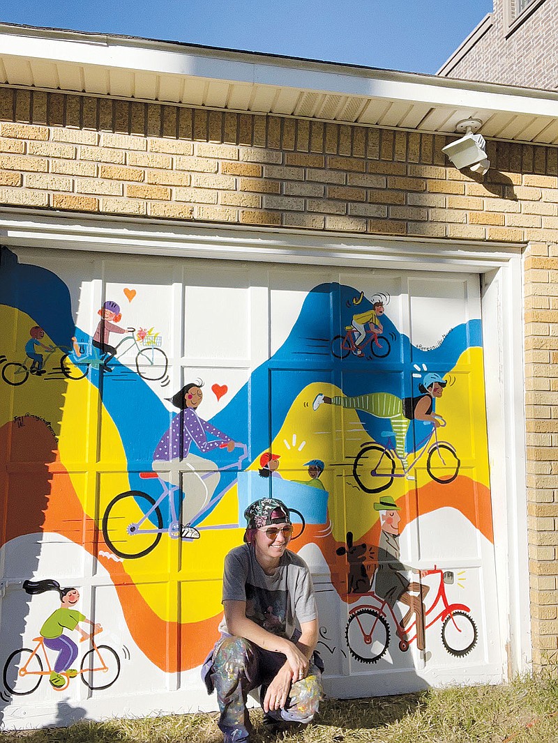 Artist Jes Weiner poses in front of a mural she created on Marley Blonskis Bike to School garage door in Bentonville. The project was funded through a mini-grant from the Bentonville Moves Coalition.
(Submitted Photo/Jes Weiner)