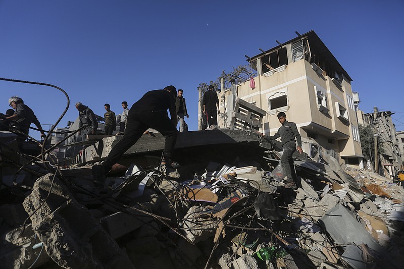 Palestinians look for survivors of the Israeli bombardment of the Gaza Strip in Rafah, Sunday, Dec. 3, 2023. (AP Photo/Hatem Ali)