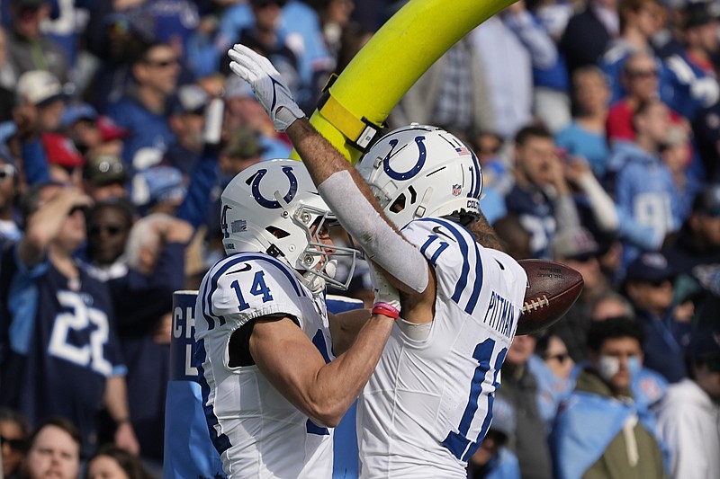 Indianapolis Colts' Alec Pierce (14) celebrates a touchdown reception with Michael Pittman Jr. during the first half of an NFL football game against the Tennessee Titans, Sunday, Dec. 3, 2023, in Nashville, Tenn. (AP Photo/George Walker IV)