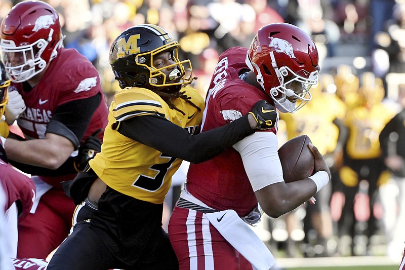Missouri defensive back Sidney Williams (3) sacks Arkansas quarterback KJ Jefferson, right,during the first half of an NCAA college football game Friday, Nov. 24, 2023, in Fayetteville, Ark. (AP Photo/Michael Woods)