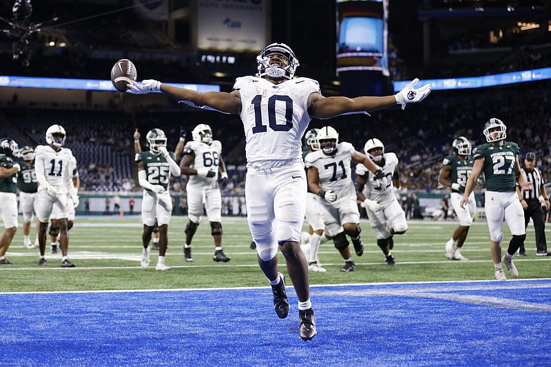 Penn State running back Nicholas Singleton (10) celebrates his touchdown against Michigan State during the second half of an NCAA college football game Friday, Nov. 24, 2023, in Detroit. (AP Photo/Al Goldis)