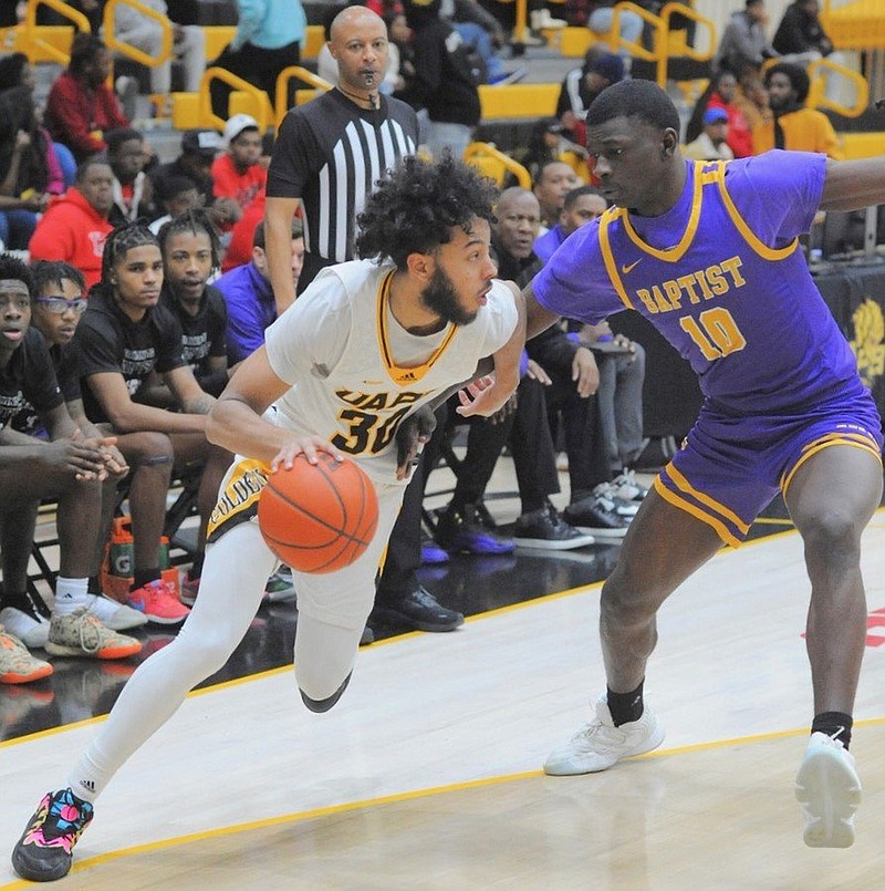 UAPB guard Joe French dribbles past Arkansas Baptist defender Makhai Helsey during a Nov. 27 basketball game at H.O. Clemmons Arena in Pine Bluff. (Special to the Commercial/William Harvey)
