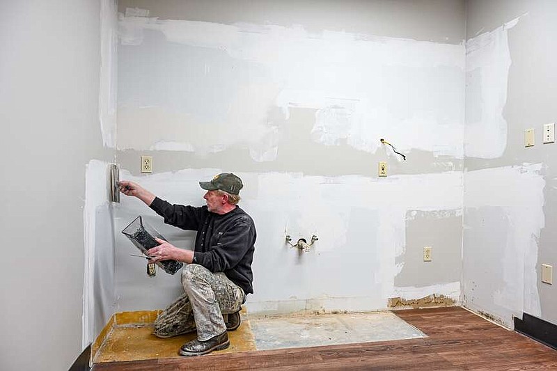 Julie Smith/News Tribune photo: 
Richard Runkle of Extreme Painting and Wallpapering of Elston applies drywall mud Tuesday, Dec. 5, 2023, to an interior room undergoing renovation at the Cole County Health Department in Jefferson City. Extreme is a subcontractor for the project contractor, GBH Builders. Multiple rooms are undergoing changes in order to repair issues or to make them better suit their designed purpose.