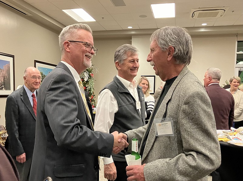 Mavis Chan/News Tribune photo: 
Randall Haight (left) shakes hands with KWOS radio host John Marsh after the ceremony that honored him as the 2023 Physician of the Year. Haight has been working at Capital Region Medical Center for more than 25 years.