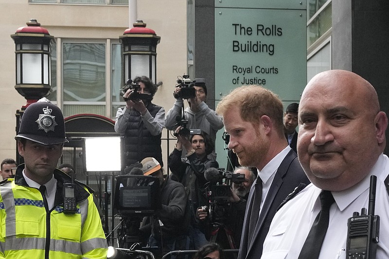 FILE - Prince Harry, second from right, escorted by security leaves the High Court after giving evidence in London, Tuesday, June 6, 2023. Prince Harry is challenging on Tuesday, Dec. 5, 2023, the British governments decision to strip him of his security detail after he gave up his status as a working member of the royal family and moved to the United States. The Duke of Sussex said he wants protection when he visits home and claimed it's partly because an aggressive press jeopardizes his safety and that of his family. (AP Photo/Frank Augstein, File)