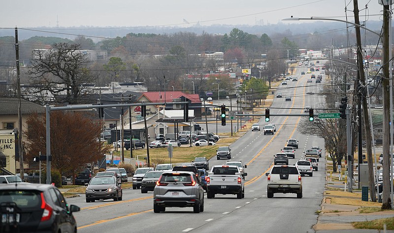 Traffic passes Friday along College Avenue near Sycamore Street in Fayetteville. The City Council on Tuesday unanimously reaffirmed its support for the 71B corridor plan that will help reshape development.
(NWA Democrat-Gazette/Andy Shupe)