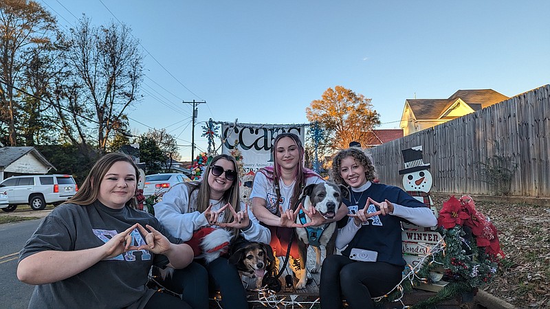 Sigma Alpha Sorority members (L to R) Chandler Merritt, Ally Ferren, Caroline Rankin and Kate Duncan sit on the Columbia County Animal Protection Society float at the 2023 Christmas Parade. Sigma Alpha members decorated the float for the parade. (Joshua Turner / Banner-News)
