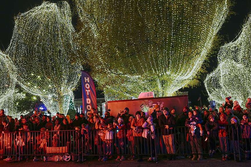 Parade attendees watch as a floats prepare to ride by, Saturday, December 10, 2022 during the annual Christmas Parade in downtown Bentonville.
(NWA Democrat-Gazette File Photo/Charlie Kaijo)