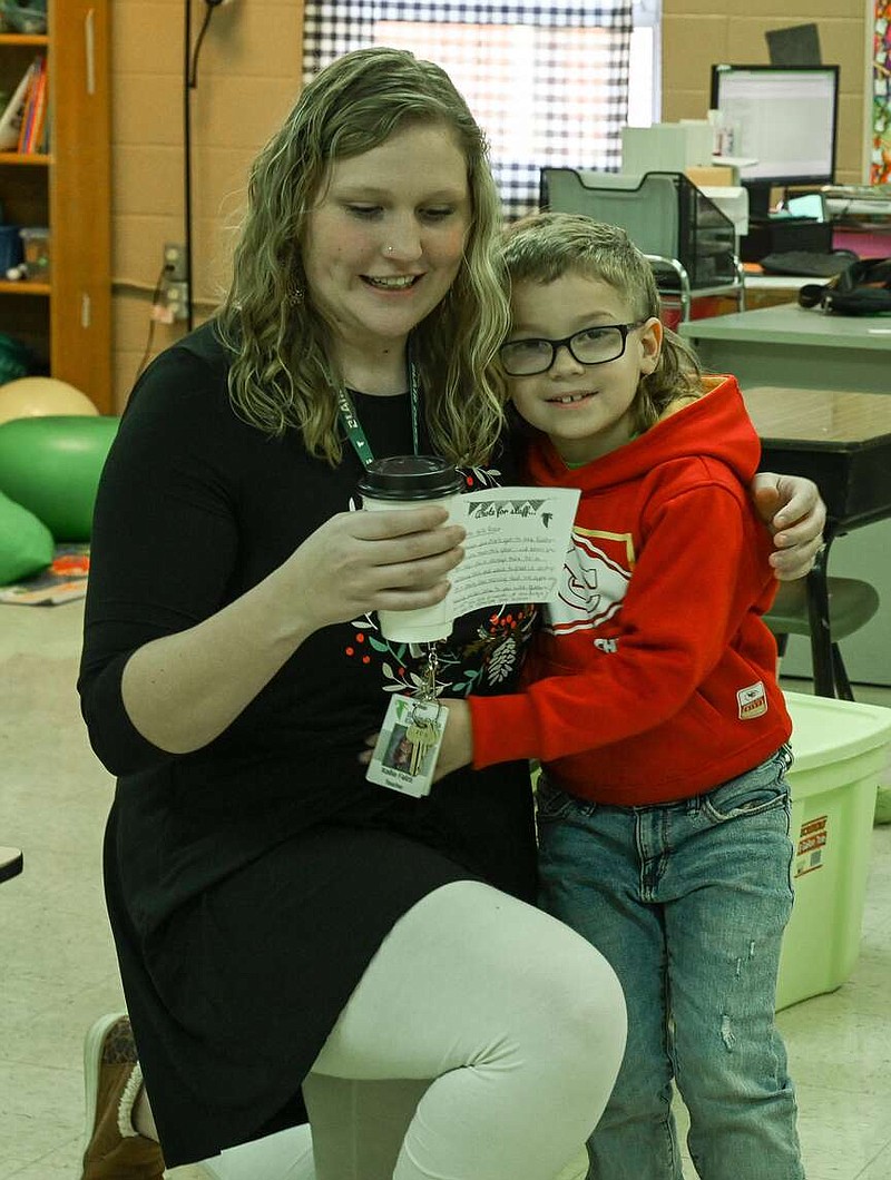 Julie Smith/News Tribune
Kalynn Adams hugs his teacher, learning specialist Kellie Falco, as she reads a note from him Thursdsay after her appreciation coffee was delivered by Tara Bishop, principal at Blair Oaks Elementary.