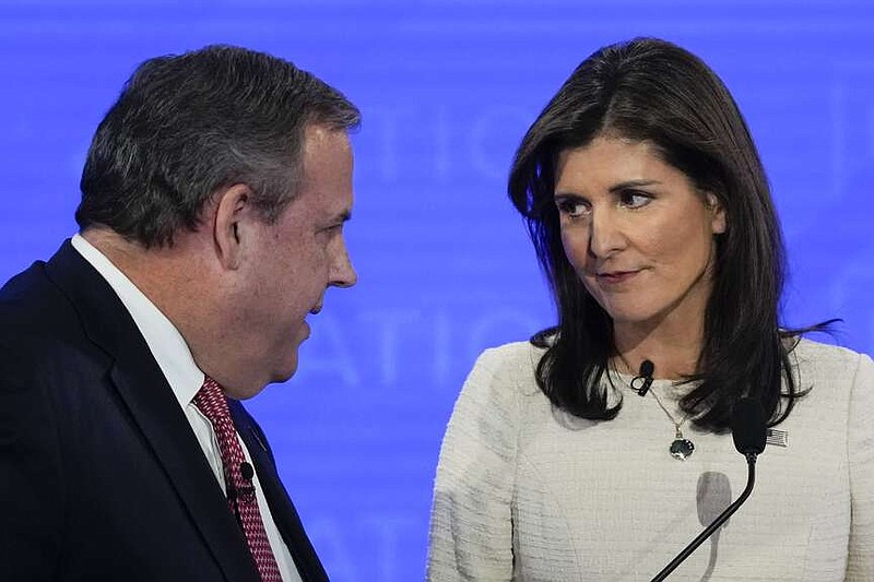 Republican presidential candidates, former New Jersey Gov. Chris Christie, left, talking with former U.N. Ambassador Nikki Haley, right, during a commercial break at a Republican presidential primary debate hosted by NewsNation on Wednesday, Dec. 6, 2023, at the Moody Music Hall at the University of Alabama in Tuscaloosa, Ala. (AP Photo/Gerald Herbert)