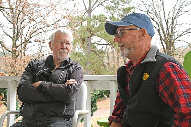 Gary Strakshus, right, discusses his book, “Somebody's Gonna Lose a Trailer,” which chronicles his 45-plus years of experiences as a mobile home park owner and manager as local artist Gary Simmons, who did the illustrations for the book, listens at Brundage Woods Mobile Home Village. (The Sentinel-Record/Lance Brownfield)
