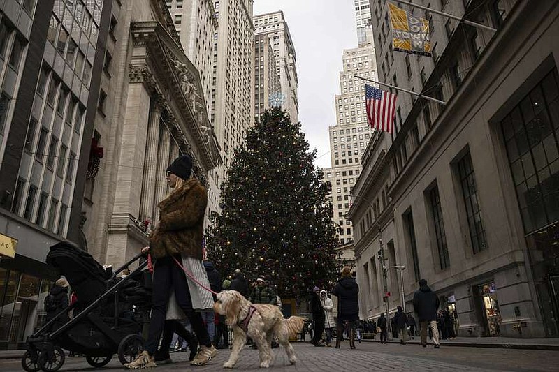 People walk past the New York Stock Exchange, Monday, Dec. 11, 2023, in New York. Stocks drifted higher in afternoon trading Monday on Wall Street ahead of the Federal Reserve's last meeting of the year. (AP Photo/Yuki Iwamura)