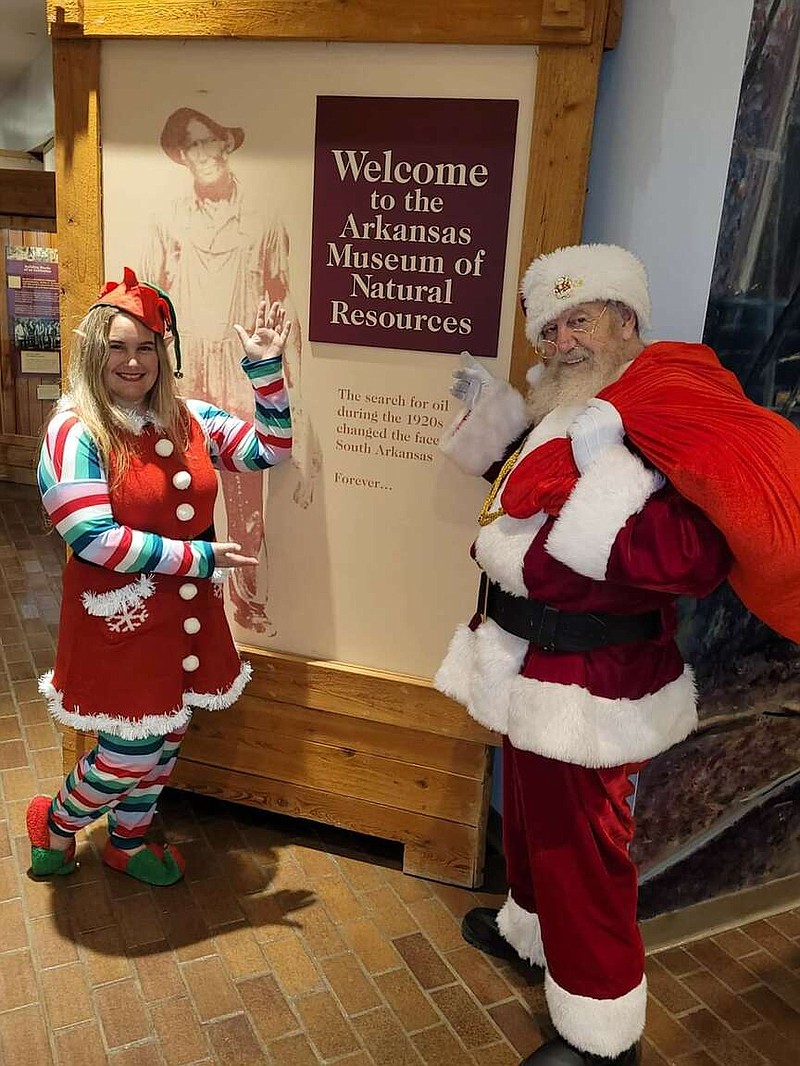 Courtesy photo
Katie Reavis, left, visits the Arkansas Museum of Natural Resources in Smackover with her father, Paul Long, a professional Santa.