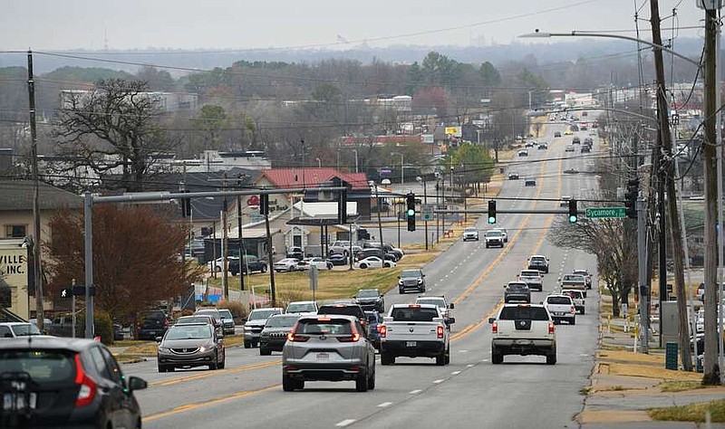 Traffic passes Dec. 1 along College Avenue near Sycamore Street in Fayetteville. The city on Wednesday was awarded a $25 million Safe Streets for All grant from the U.S. Department of Transportation to put toward capital projects, including adding sidewalks and pedestrian safety measures to College Avenue from Sycamore to Township streets.
(File photo/NWA Democrat-Gazette/Andy Shupe)