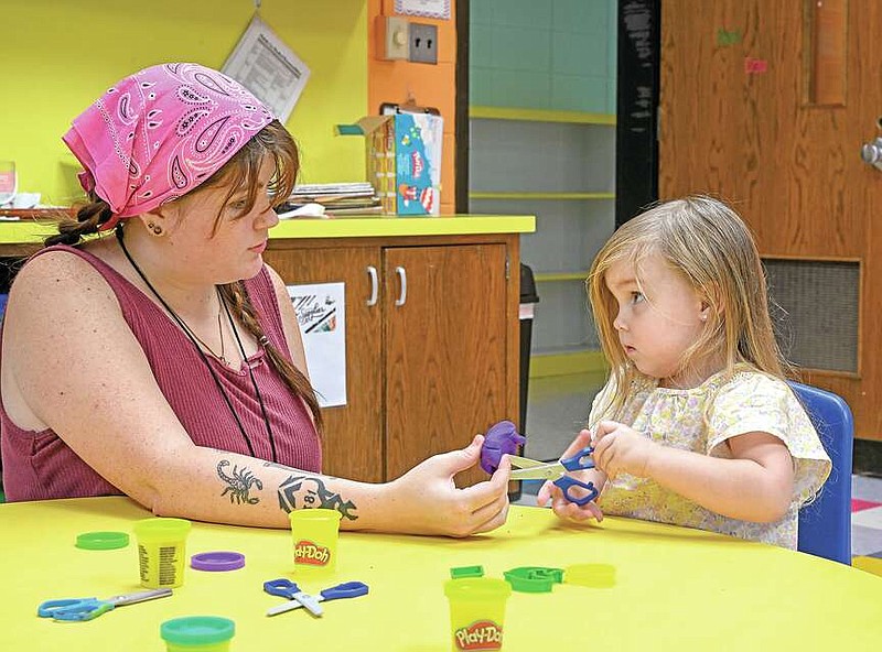 Teacher Hannah Garrett plays with new preschooler Kinzley Greenfield on Thursday, August 10th, 2023 at the open house for the Community School of the Arts in Fort Smith. The school provides students with opportunities to explore and develop their various artistic abilities as well as develop their social skills in positive ways. Visit nwaonline.com/photo for today's photo gallery. (NWA Democrat-Gazette/Caleb Grieger)