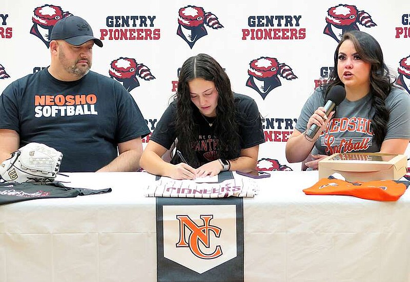 Randy Moll/Westside Eagle Observer
Gentry senior Favy Najar signs her letter of intent to attend and play softball at Neosho County Community College in Chanute, Kan., next school year. Beside her at the Dec. 12 signing ceremony at Gentry High School are her parents, Dustin Clapp and Roxy Najar.