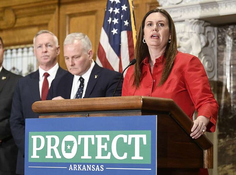 Arkansas Gov. Sarah Huckabee Sanders announces a $470 million criminal justice package during a news conference at the state Capitol in this March 27, 2023 file photo. Listening are (from left) Arkansas Corrections Department Secretary Joe Profiri and Attorney General Tim Griffin. (Arkansas Democrat-Gazette/Stephen Swofford)