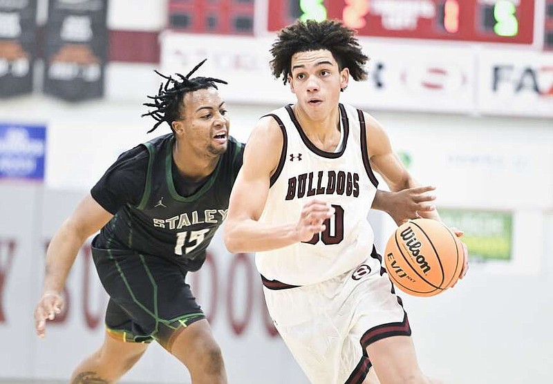 Springdale guard Isaiah Sealy (30) drives the ball forward, Friday, December 15, 2023 during the second half of a basketball game at Bulldog Gym at Springdale High School in Springdale. Visit nwaonline.com/photos for today's photo gallery.

(NWA Democrat-Gazette/Charlie Kaijo)