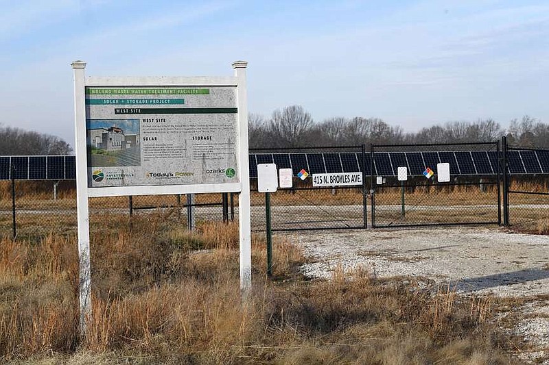 A sign stands Wednesday, Dec. 13, 2023, outside a large solar panel array north of the West Side Wastewater Treatment Facility in Fayetteville. The city is hoping to build a new solar array to offset municipal energy costs before the state's new net metering rules take effect at the end of September. Visit nwaonline.com/photo for today's photo gallery.
(NWA Democrat-Gazette/Andy Shupe)