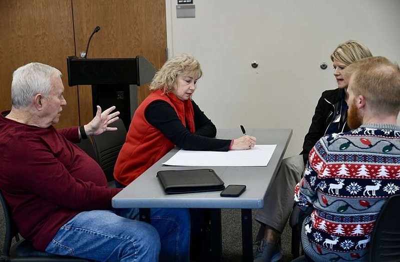 From left, Lee Richardson, Rhonda Harrington, Beverly Joe, and Corey Alderdice discuss qualities they would like to see in National Park College's next president during a roundtable discussion on Dec. 14 at the Garland. County Library. (The Sentinel-Record/Lance Brownfield)