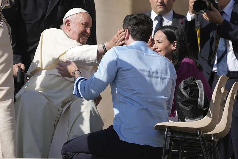 FILE - Newly couples of weds meet with Pope Francis during the weekly general audience in St. Peter's Square at the Vatican, on Oct. 11, 2023. Pope Francis has formally approved allowing priests to bless same-sex couples, with a new document released Monday Dec. 18, 2023 explaining a radical change in Vatican policy by insisting that people seeking God's love and mercy shouldn't be subject to “an exhaustive moral analysis” to receive it. (AP Photo/Gregorio Borgia, File)