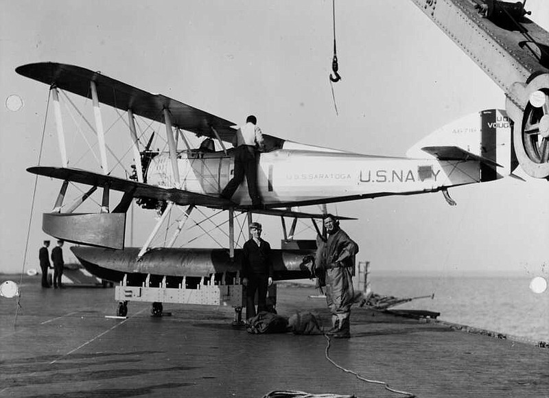 Aboard the USS Saratoga on Jan. 10, 1928, Lt. Comdr. John D. Price (right) stands with an unidentified mail orderly in front of a Vought VO-1 seaplane Price had just flown on a mail trip from Hampton Roads, Va., to the Delaware Breakwater. (Naval History and Heritage Command National Archives)
