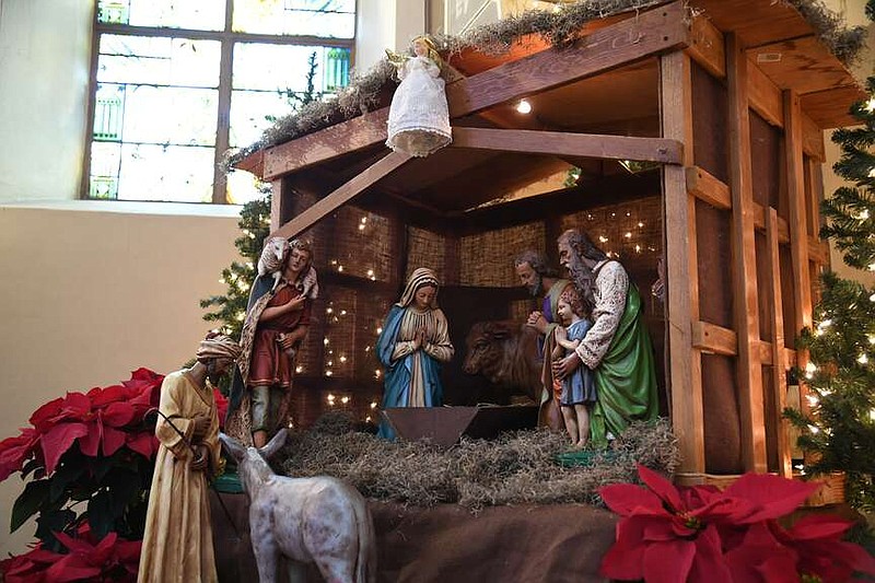 A nativity display is set up in the front of the sanctuary at St. John the Baptist Catholic Church. (The Sentinel-Record/Lance Brownfield)