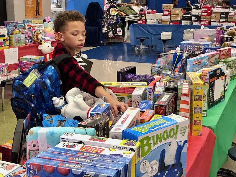 Joe Gamm/News Tribune
Wyatt Bridgeforth, a third-grader, selects two toys Wednesday afternoon to take home during the Jefferson City Boys & Girls Club Christmas program at the Railton Center.