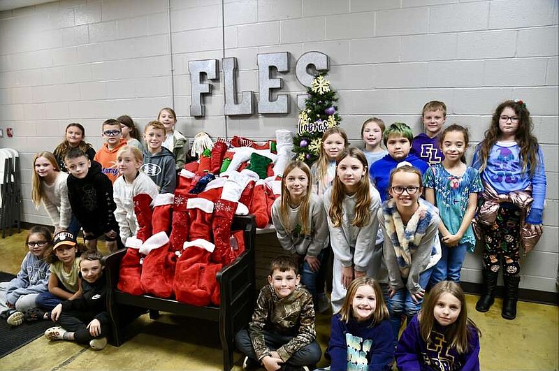 Third grade students at Fountain Lake Elementary School are shown with their stuffed stockings for Jackson House in the hallway of the school on Wednesday. (The Sentinel-Record/Lance Brownfield)