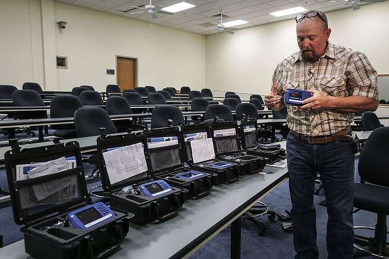 Russell Johnson, a contract instructor for Thermo Scientific, demostrates the new TruNarc Handheld Narcotics Analyzer that the Arkansas State Police received during a press conference at Police headquarters in Little Rock Wednesday, Oct 10, 2018. (Arkansas Democrat-Gazette/MITCHELL PE MASILUN)
