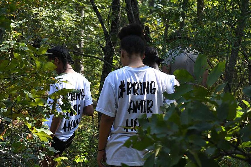 A group led by Amir Ellis' mother, Jessica Ellis, searches the woods near Jessieville for her son earlier this summer. - (The Sentinel-Record/Lance Brownfield/File)