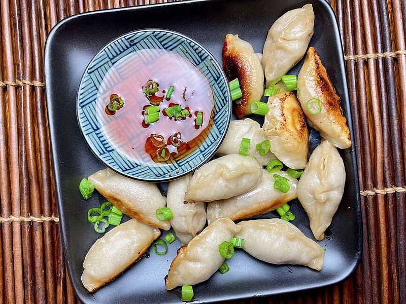 Potstickers with sweet chile dipping sauce and green onions (Arkansas Democrat-Gazette/Kelly Brant)