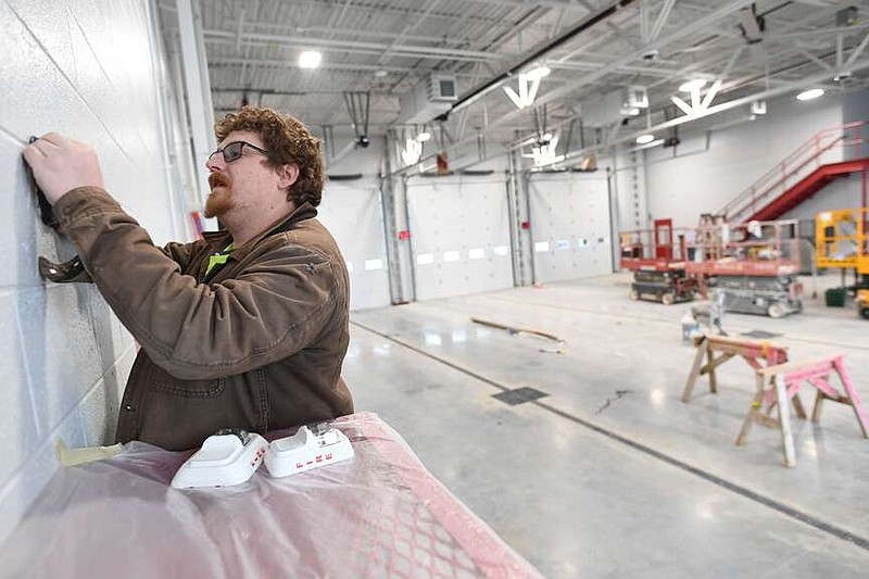 Adam Brown, a technician at Progressive Technologies, installs a fire alarm strobe Thursday, Dec. 28, 2023, while putting the finishing touches on the low-voltage systems in the Tontitown Fire Department Station 1 in Tontitown. The 12,000-square-foot station was constructed with the approval of a $5.3 million bond by voters in 2021 and is expected to open in the coming weeks. Visit nwaonline.com/photo for today's photo gallery.
(NWA Democrat-Gazette/Andy Shupe)