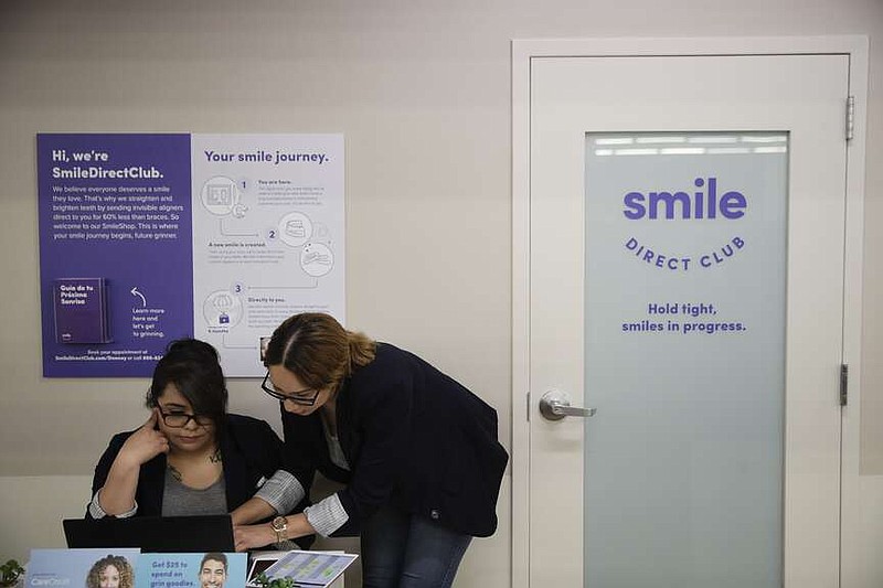 FILE - Dental assistants go over appointments at SmileDirectClub's SmileShop located inside a CVS store April 24, 2019, in Downey, Calif. SmileDirectClub is shutting down, just months after the struggling teeth-straightening company filed for bankruptcy, leaving existing customers in limbo. On Friday, Dec. 8, 2023, the company said it was unable to find a partner willing to bring in enough capital to keep the company afloat, despite a months-long search. (AP Photo/Jae C. Hong)