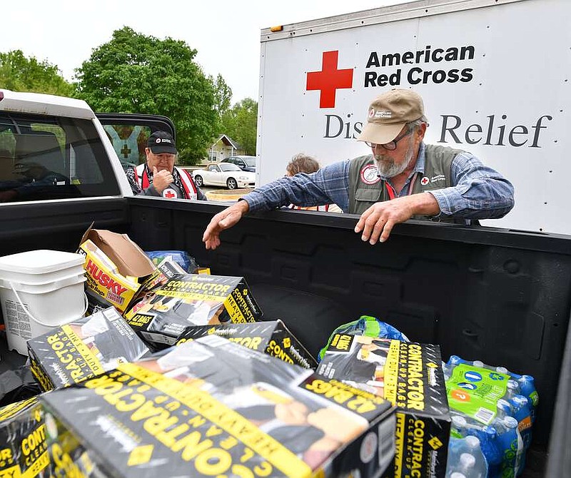 American Red Cross volunteer Mike Kratchmer (right) unloads boxes of trash bags, food and other supplies Friday, May 6, 2022, at Genesis Church in south Fayetteville. (NWA Democrat-Gazette/Andy Shupe)