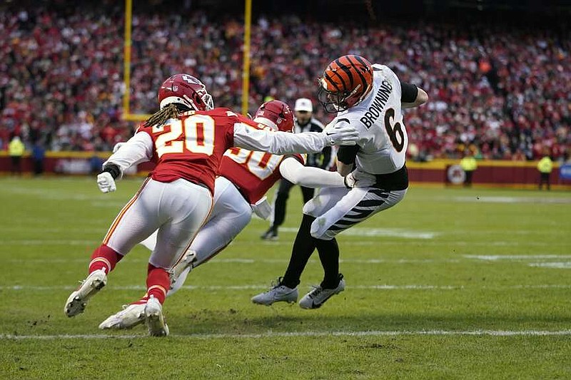 Cincinnati Bengals quarterback Jake Browning (6) scores past Kansas City Chiefs safety Justin Reid (20) and linebacker Willie Gay (50) during the first half of an NFL football game Sunday, Dec. 31, 2023, in Kansas City, Mo. (AP Photo/Ed Zurga)