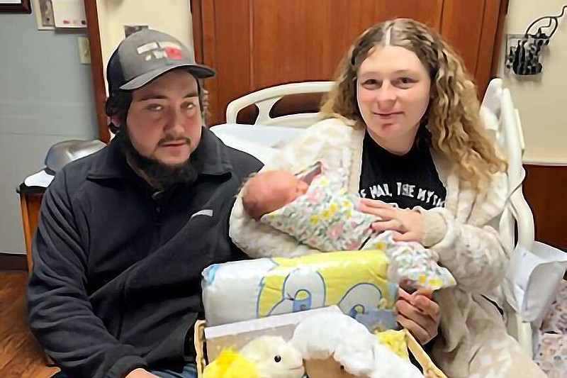 Dusty Lansdell, left, and Jacquelynn Lansdell hold their daughter Izzabella on New Year's Day 2024 at CHRISTUS St. Michael Hospital in Texarkana, Texas. Delivered at 12:11 a.m. Jan. 4, 2024, by Dr. AnnMarie Ledley, Izzabella was the first child born at the hospital this year. (Photo courtesy of CHRISTUS St. Michael)