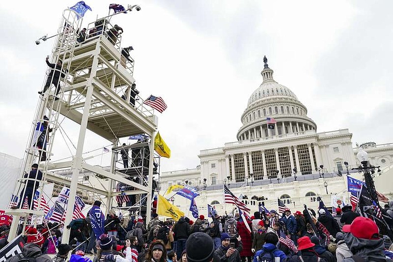 FILE - Thousands of people loyal to President Donald Trump breach the U.S. Capitol in Washington, Jan. 6, 2021. (AP Photo/John Minchillo, File)